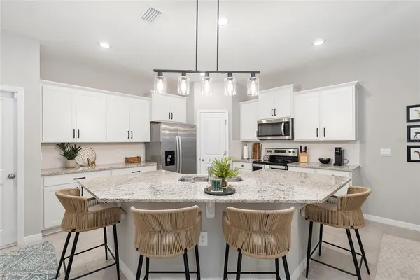 a bathroom with a granite countertop toilet sink and mirror