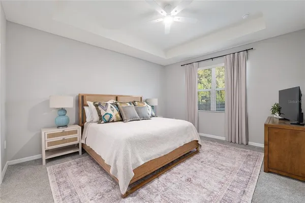 a bathroom with a granite countertop sink mirror vanity and toilet