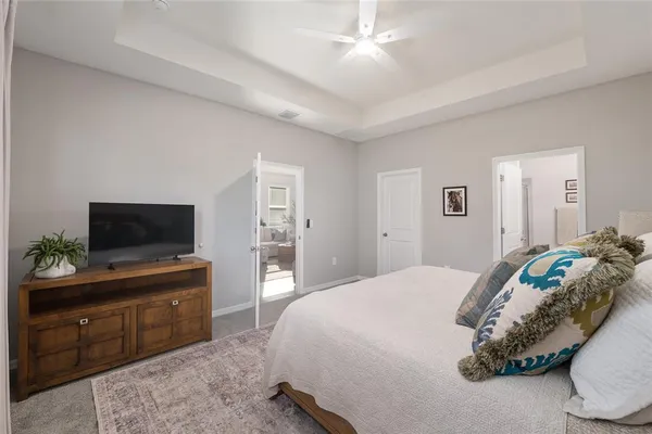 a living room with large windows and a table