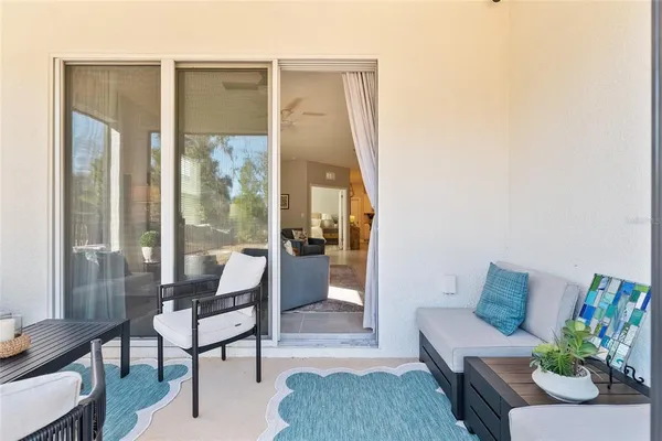 a view of a patio with table and chairs and potted plants