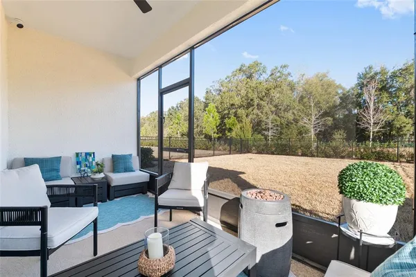 a view of a swimming pool with a yard and sitting area