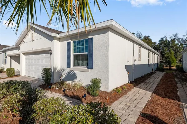 a vase of flowers sitting on a floor