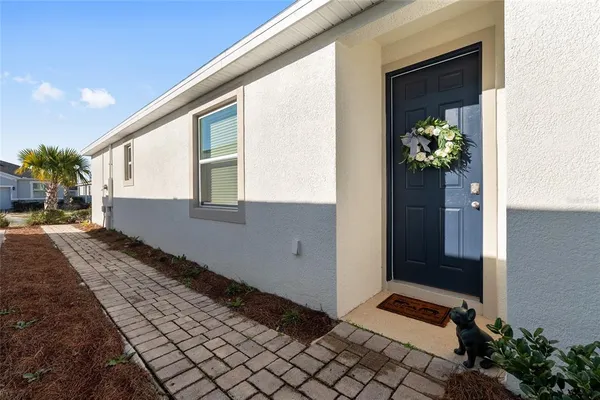 a living room with furniture and view of kitchen