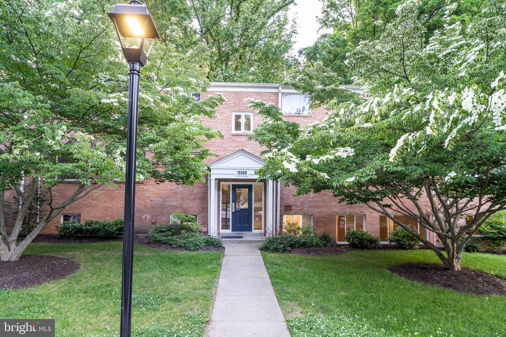 10500 Montrose Avenue, Unit M4 Rockville, MD 20852 - Photo 14 of 17 a front view of a house with garden