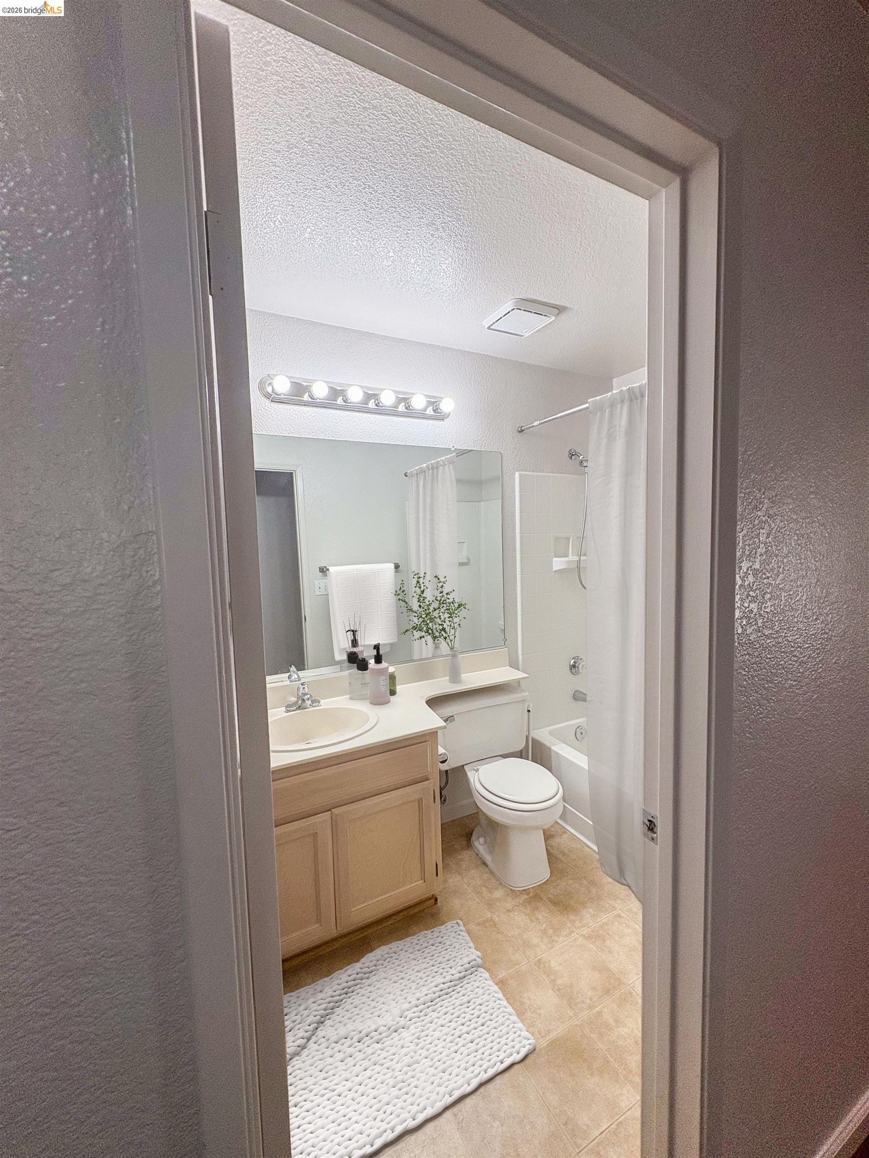 256 Napoli Court Hercules, CA 94547 - Photo 12 of 14 a bathroom with a toilet a sink and a mirror