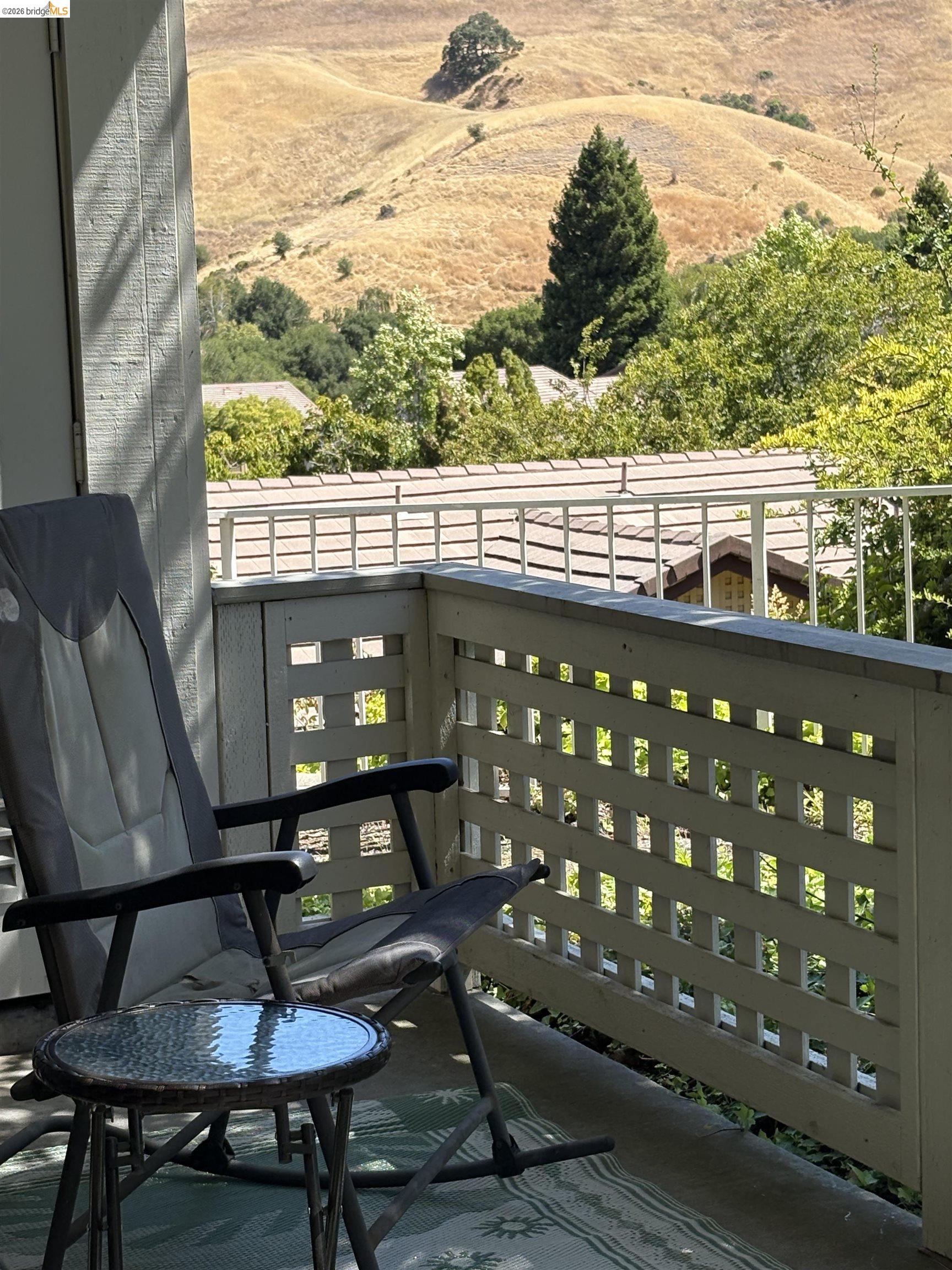 256 Napoli Court Hercules, CA 94547 - Photo 4 of 14 a view of a balcony with chairs and wooden fence