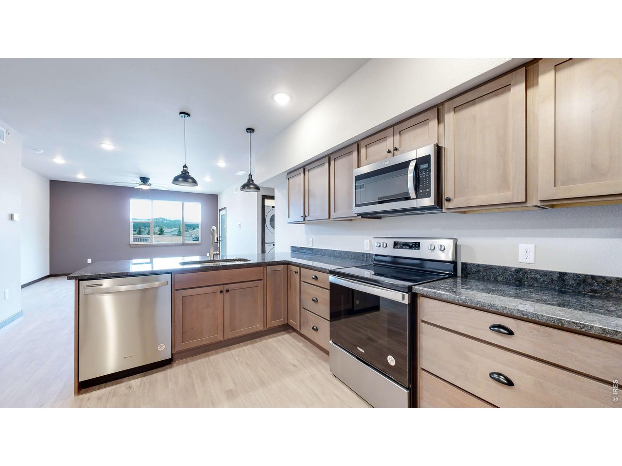 1734 Wildfire Road, Unit 204 Estes Park, CO 80517 - Photo 12 of 31 a kitchen with stainless steel appliances granite countertop a sink a stove microwave and cabinets
