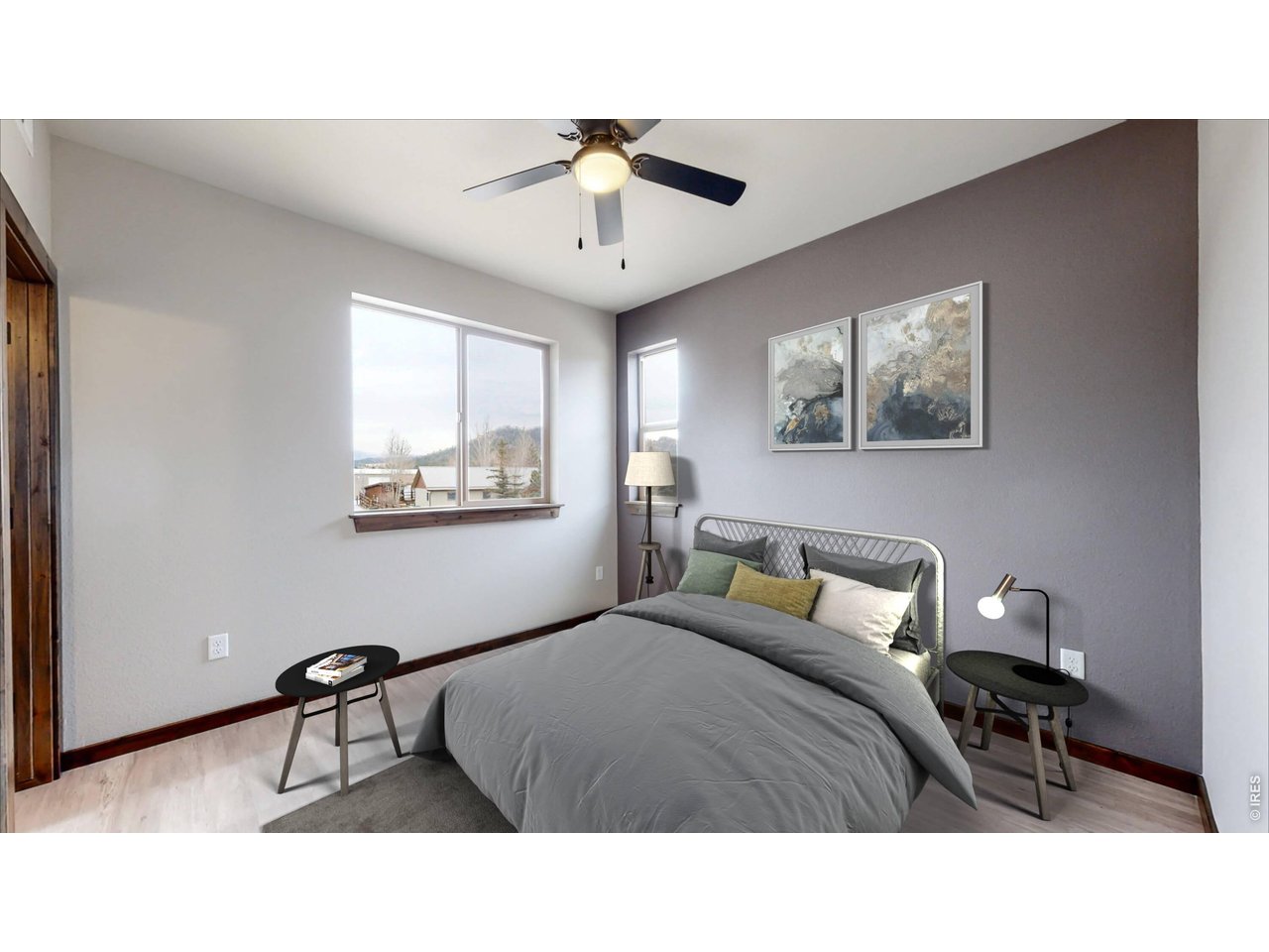 1734 Wildfire Road, Unit 204 Estes Park, CO 80517 - Photo 20 of 31 a bedroom with a bed and a chandelier