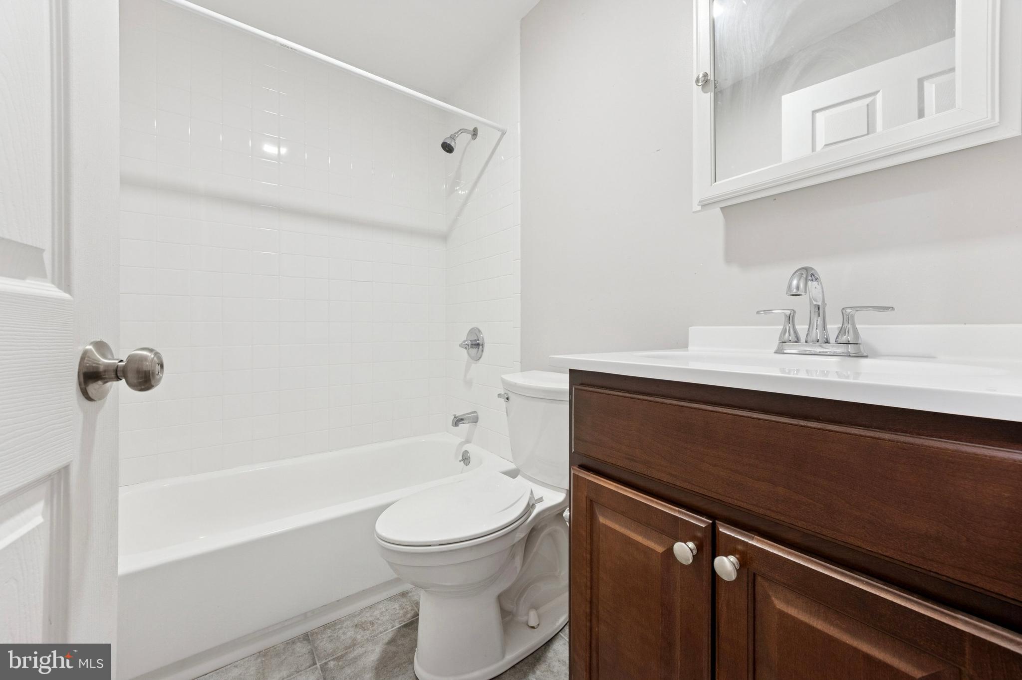 4602 Longshore Avenue Philadelphia, PA 19135 - Photo 12 of 16 a bathroom with a sink a toilet and a bathtub