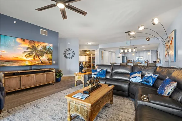 a living room with furniture and a wooden floor