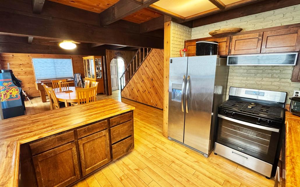6330 Caldor Road Somerset, CA 95684 - Photo 11 of 30 a kitchen with stainless steel appliances wooden cabinets a sink and a stove