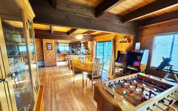 a view of a living room with furniture and floor to ceiling window