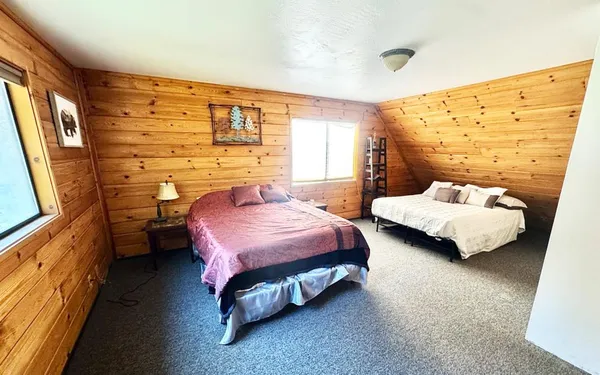 a bedroom with a bed and a night stand