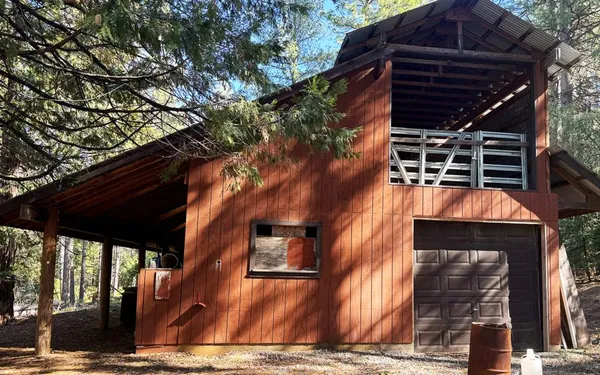 a backyard of a house with table and chairs