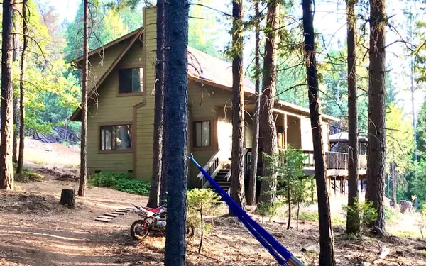 a view of a house with a tree in front