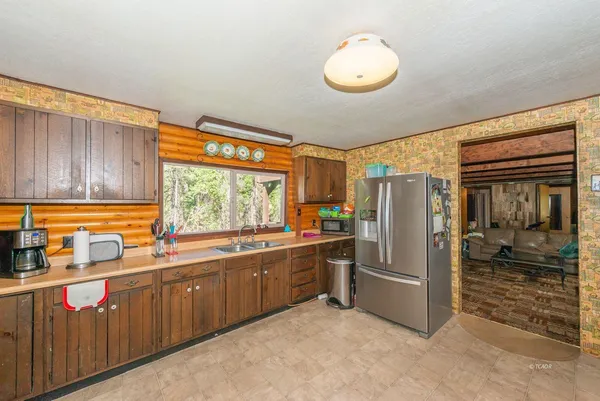 a kitchen with stainless steel appliances a refrigerator and a sink