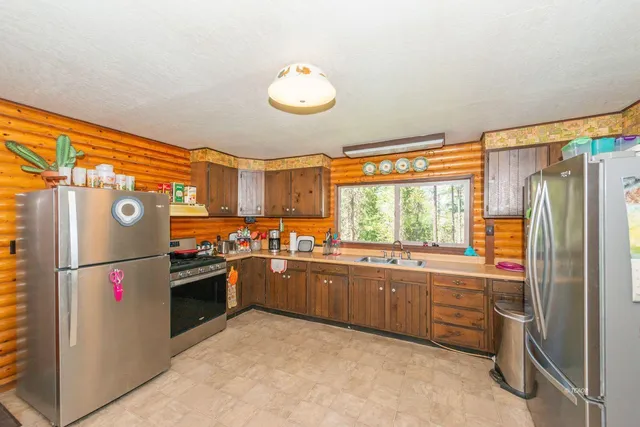 a kitchen with refrigerator and window