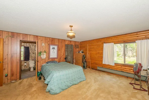 a bedroom with a bed and a large window