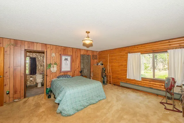 a bedroom with a bed and a large window