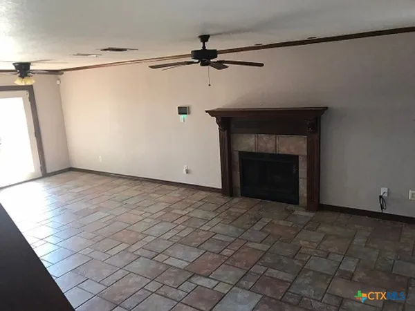 a view of an empty room with a fireplace