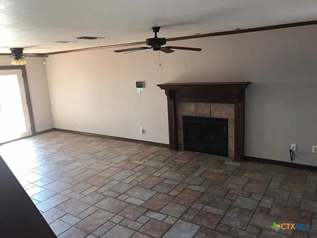 a view of an empty room with a fireplace