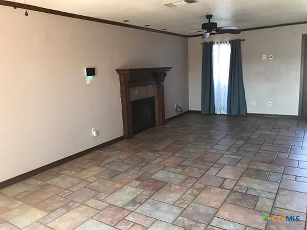 a view of a livingroom with a fireplace and a chandelier