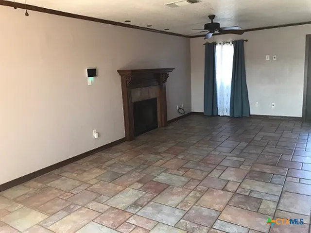 a view of a livingroom with a fireplace and a chandelier