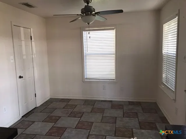 a view of an empty room with a window