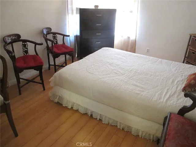 a bedroom with bed and chair