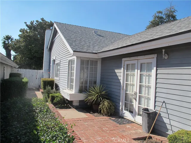 a view of backyard with a table and chairs and potted plants