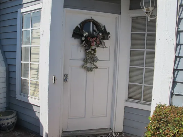 a view of hallway with shower and wooden floor
