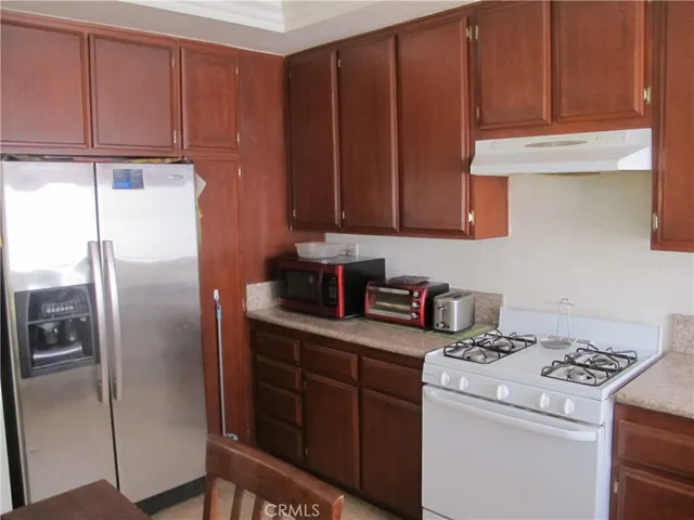 a kitchen with appliances cabinets and a counter top space