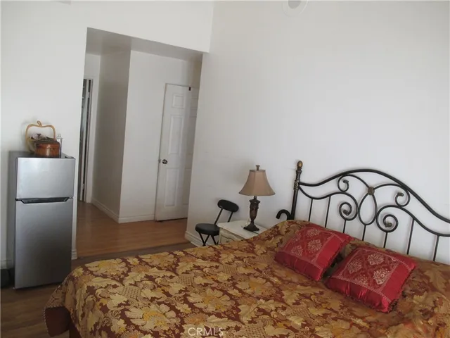 a bedroom with bed and a mirror