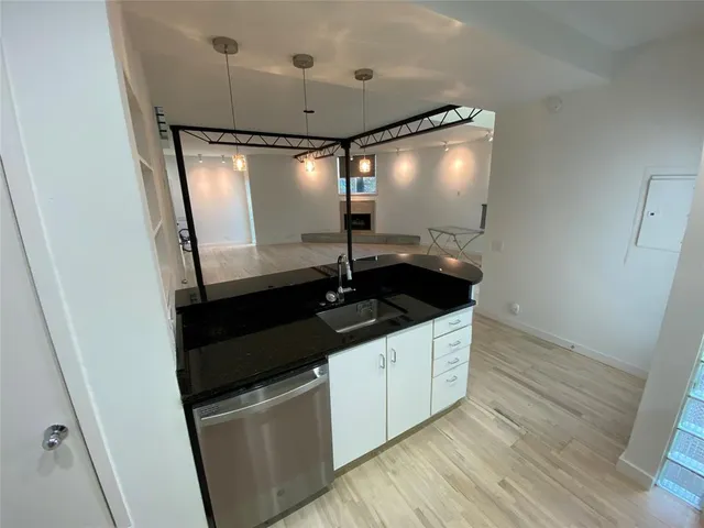a kitchen with a sink and refrigerator