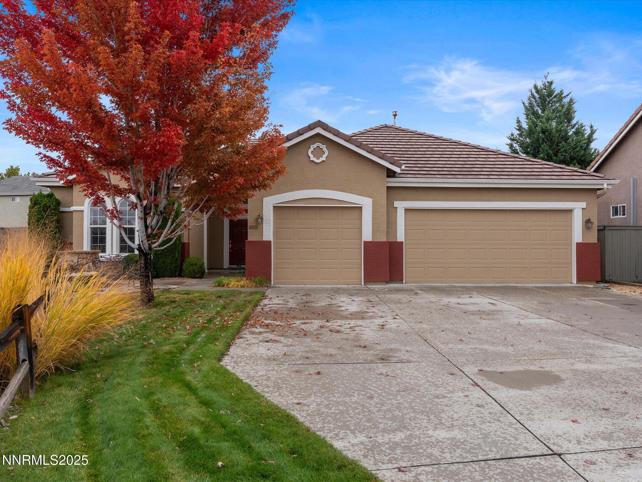 10316 Sterling View Court Reno, NV 89521 - Photo 1 of 41 a front view of a house with a yard and garage