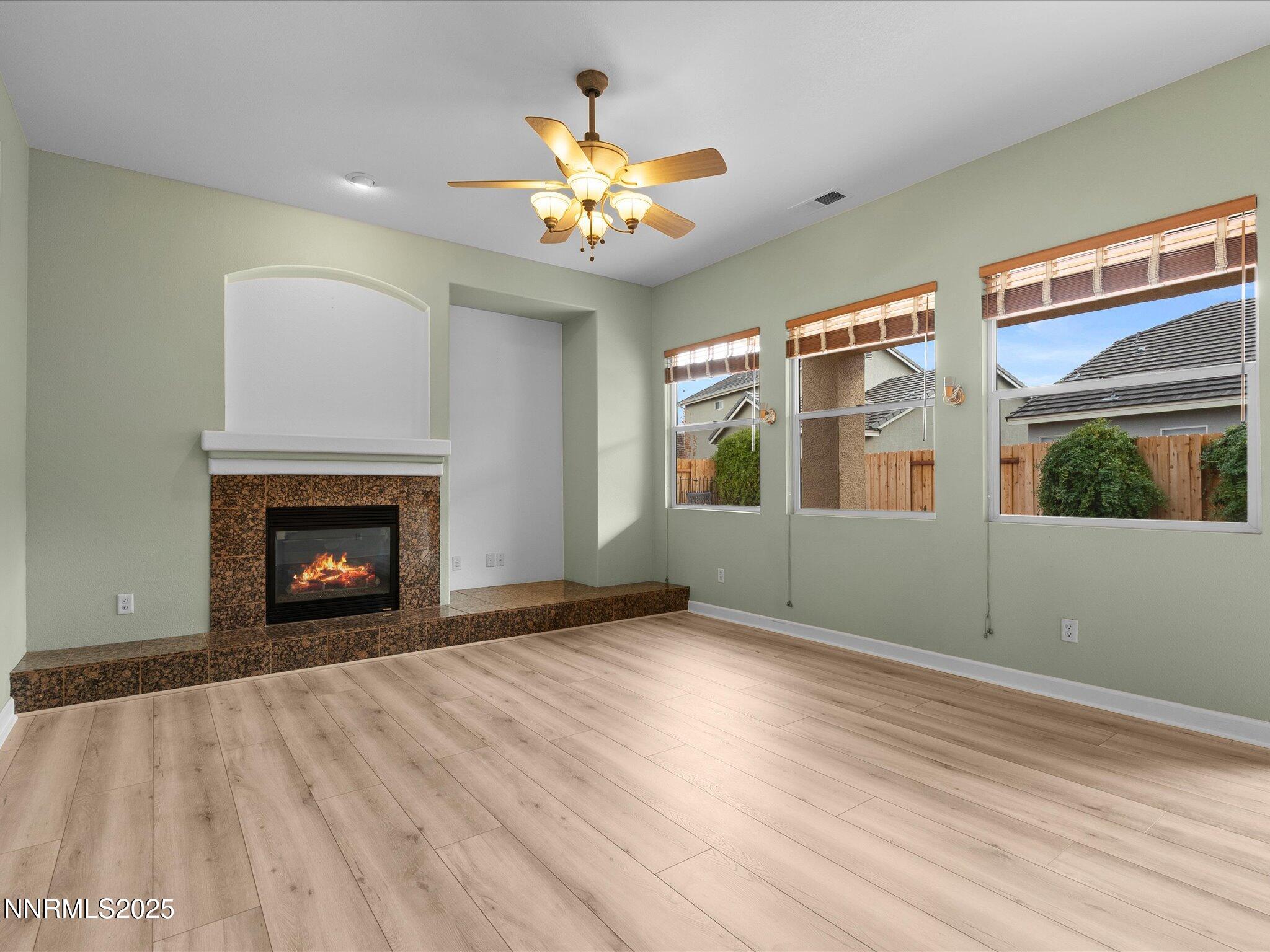 10316 Sterling View Court Reno, NV 89521 - Photo 11 of 41 a view of an empty room with window and wooden floor