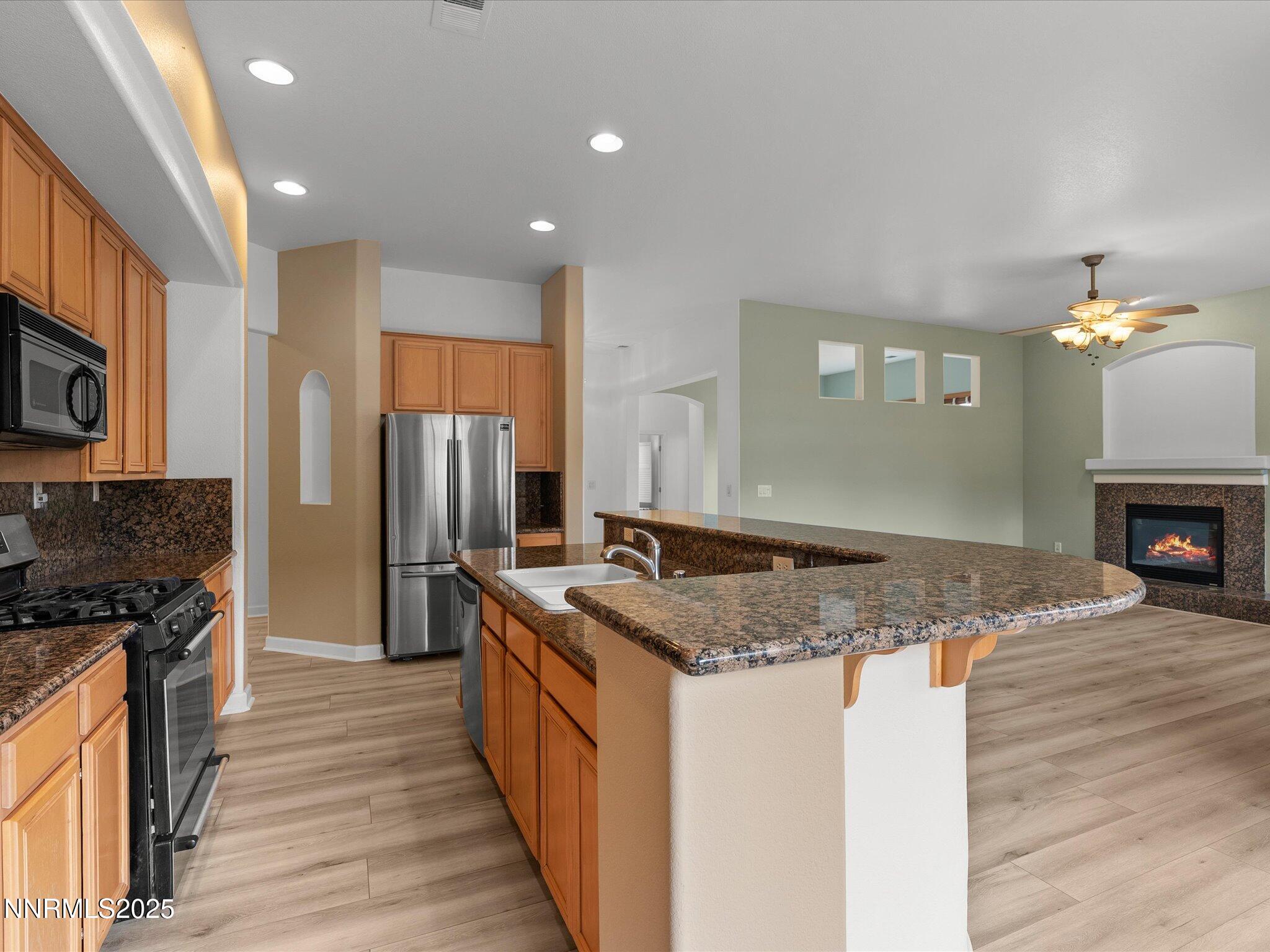 10316 Sterling View Court Reno, NV 89521 - Photo 14 of 41 a kitchen with stainless steel appliances granite countertop a sink stove and refrigerator