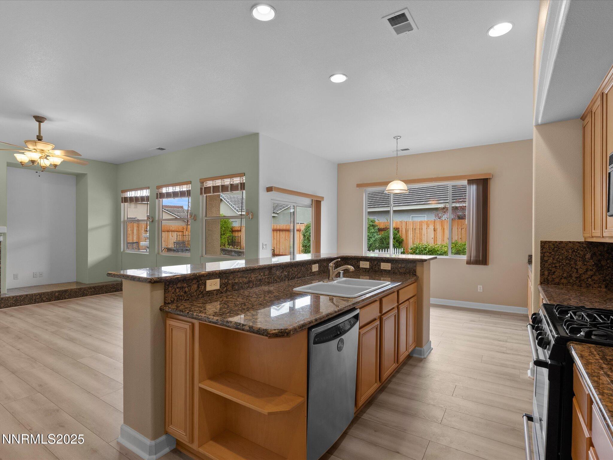 10316 Sterling View Court Reno, NV 89521 - Photo 15 of 41 a kitchen with granite countertop a stove and a sink
