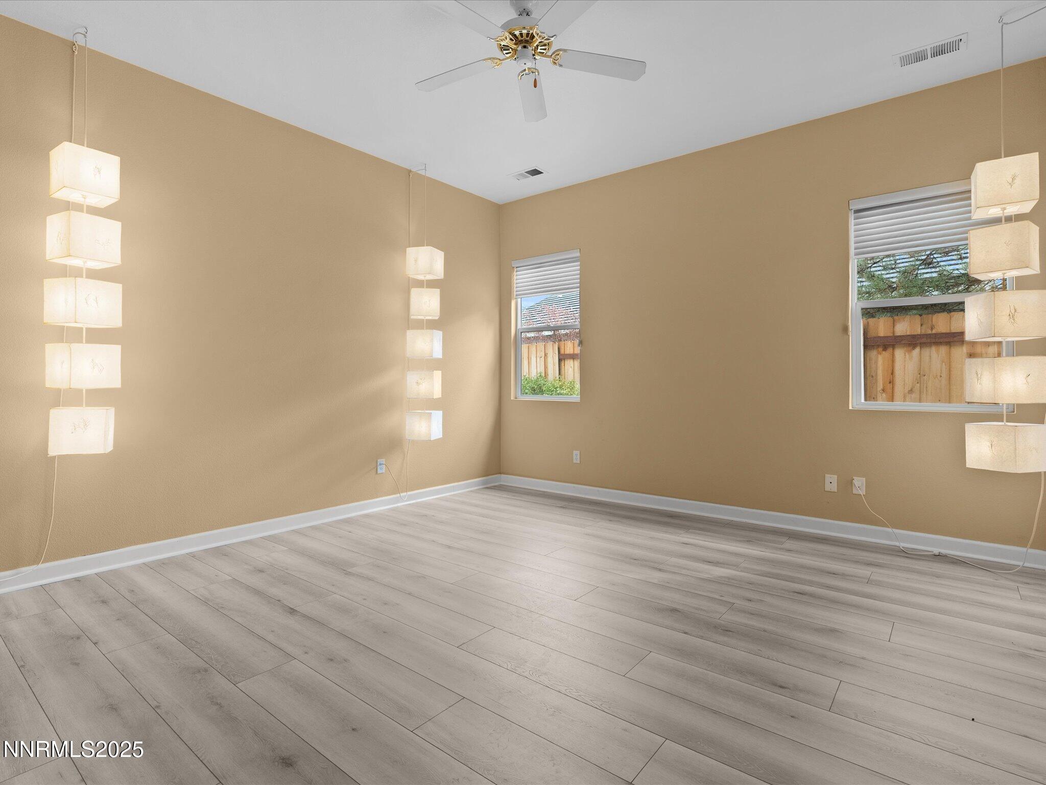 10316 Sterling View Court Reno, NV 89521 - Photo 17 of 41 wooden floor in an empty room with a window