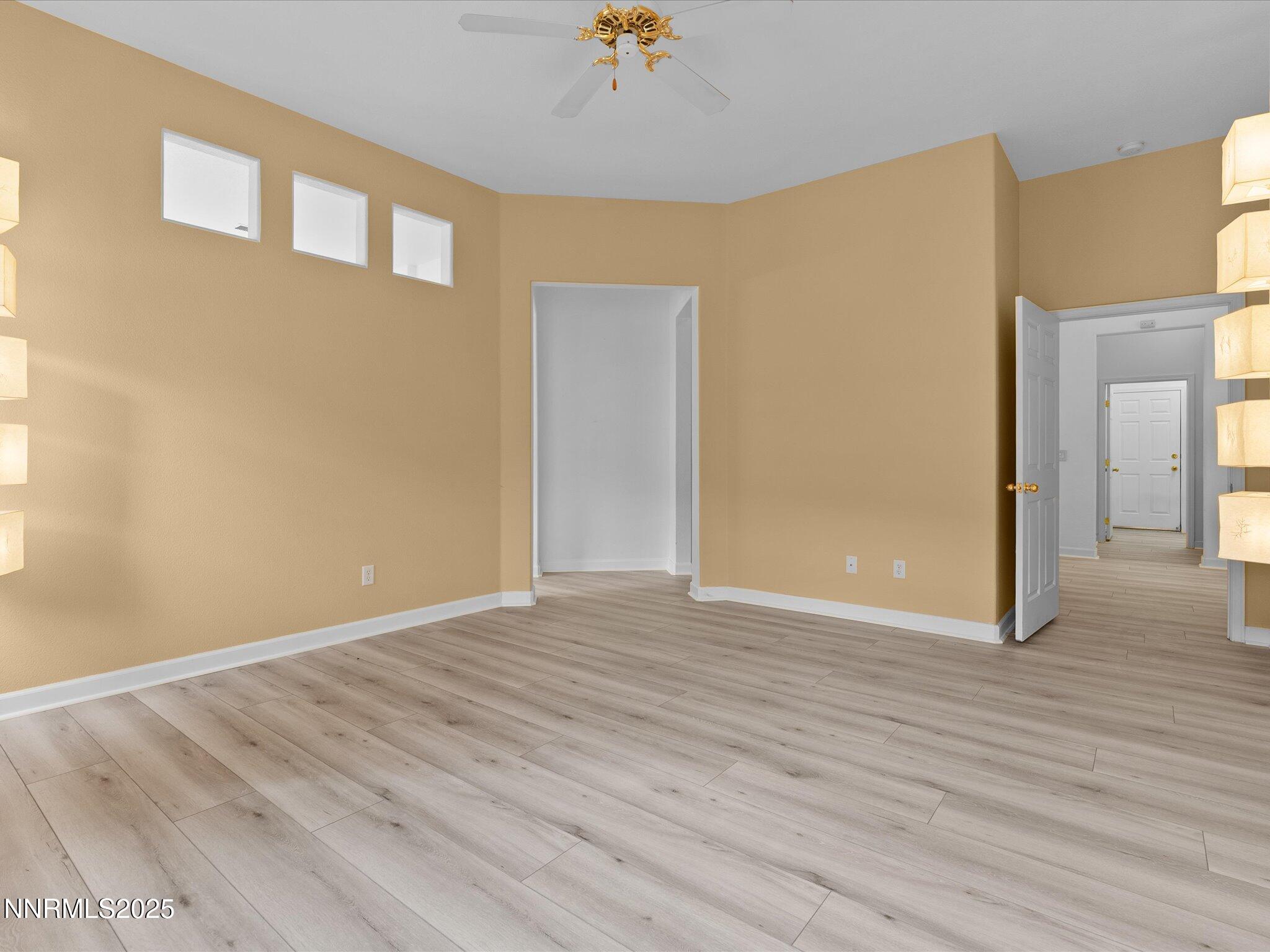 10316 Sterling View Court Reno, NV 89521 - Photo 18 of 41 a view of an empty room with wooden floor and a window