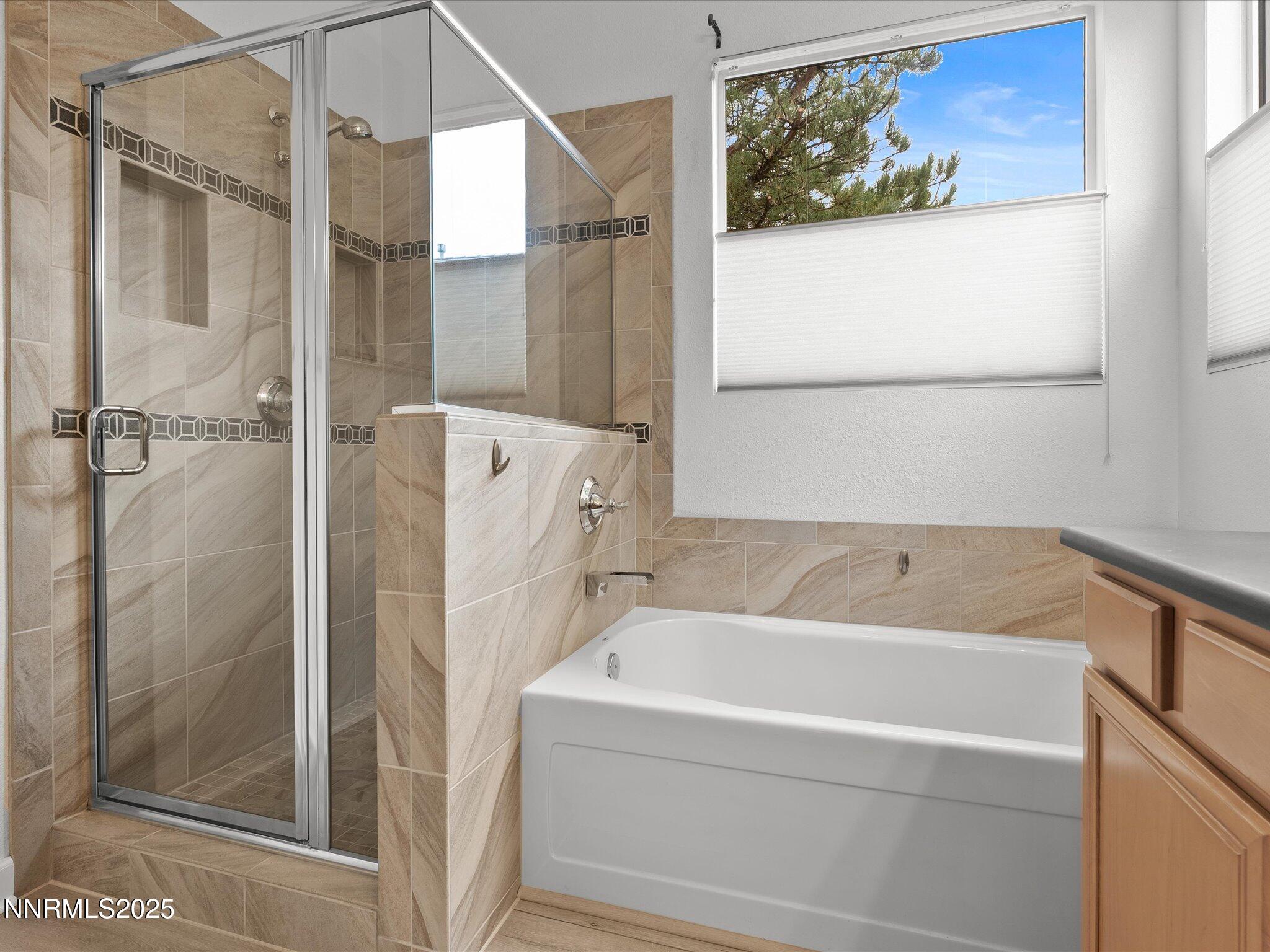 10316 Sterling View Court Reno, NV 89521 - Photo 21 of 41 a bathroom with a bathtub and a shower