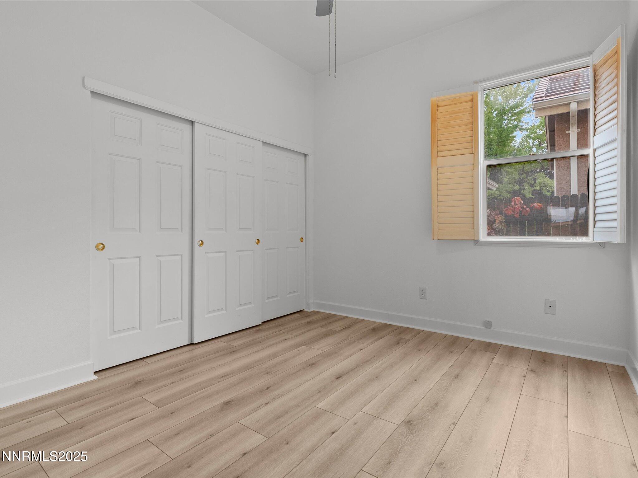 10316 Sterling View Court Reno, NV 89521 - Photo 23 of 41 a view of an empty room with wooden floor and a window