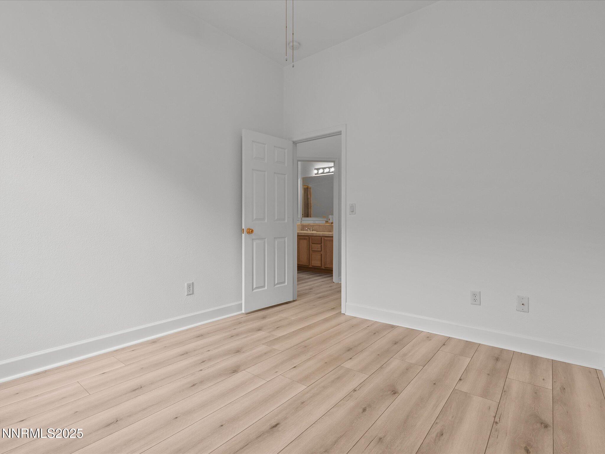 10316 Sterling View Court Reno, NV 89521 - Photo 24 of 41 a view of an empty room with wooden floor and a window