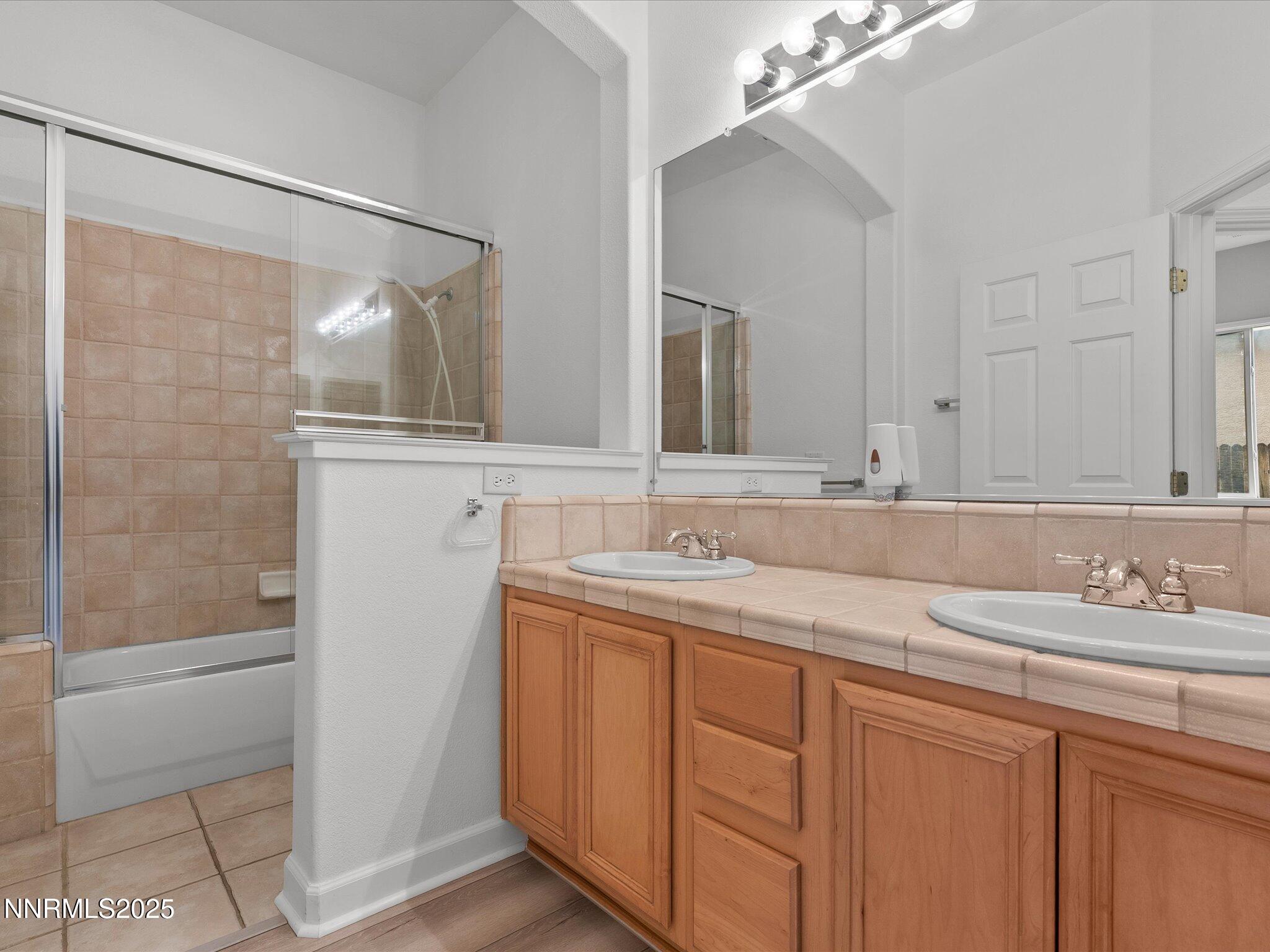 10316 Sterling View Court Reno, NV 89521 - Photo 25 of 41 a bathroom with a granite countertop sink and a mirror