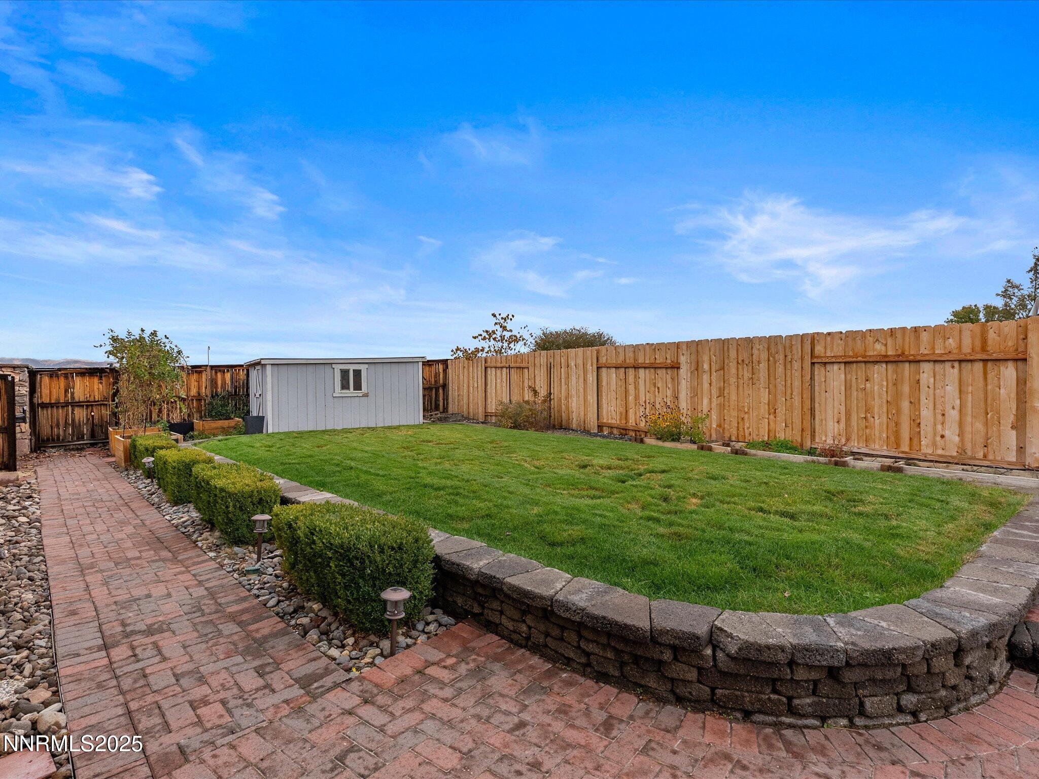 10316 Sterling View Court Reno, NV 89521 - Photo 34 of 41 a view of a backyard with brick wall and wooden fence