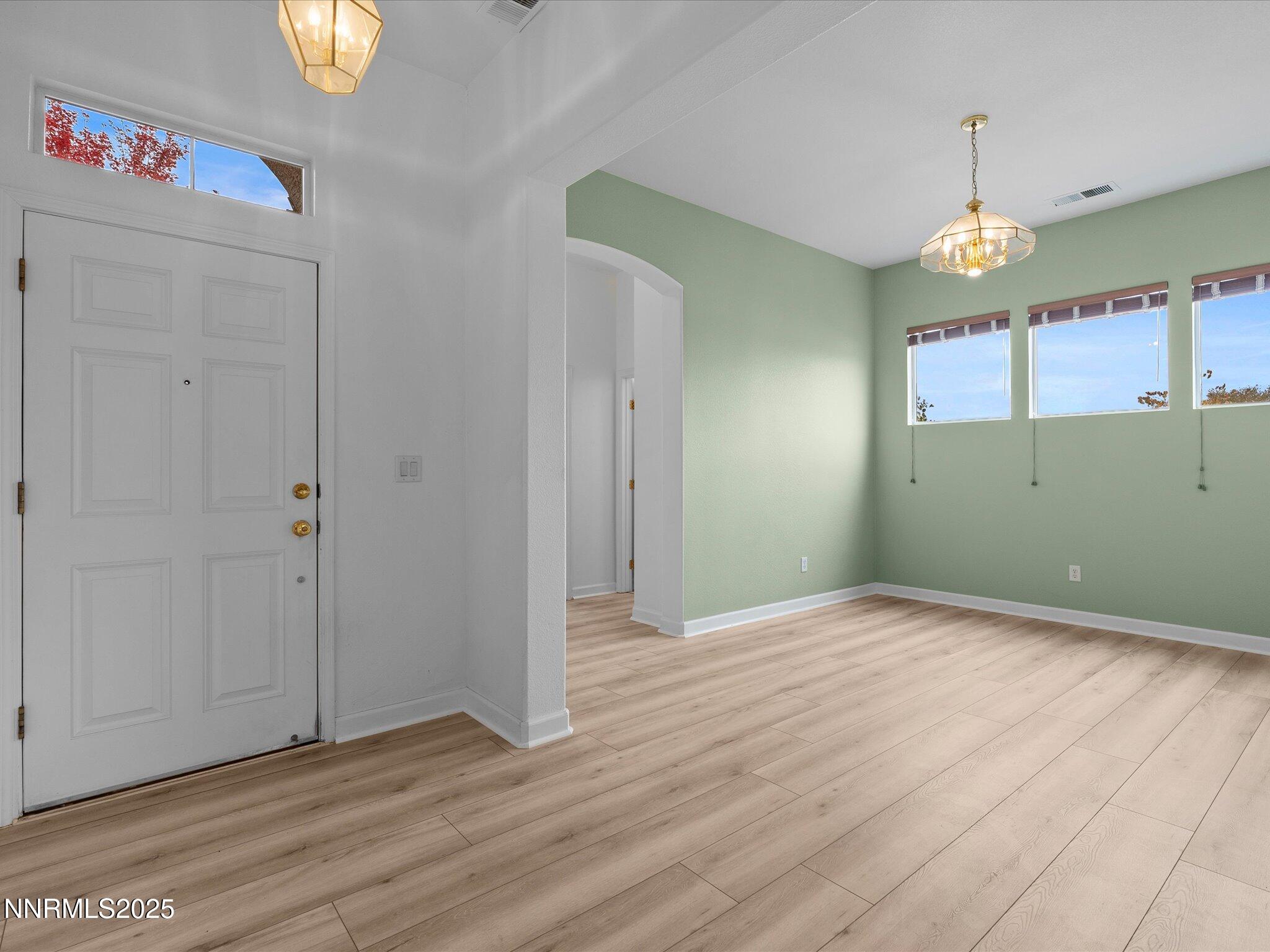 10316 Sterling View Court Reno, NV 89521 - Photo 6 of 41 a view of an empty room with window and wooden floor