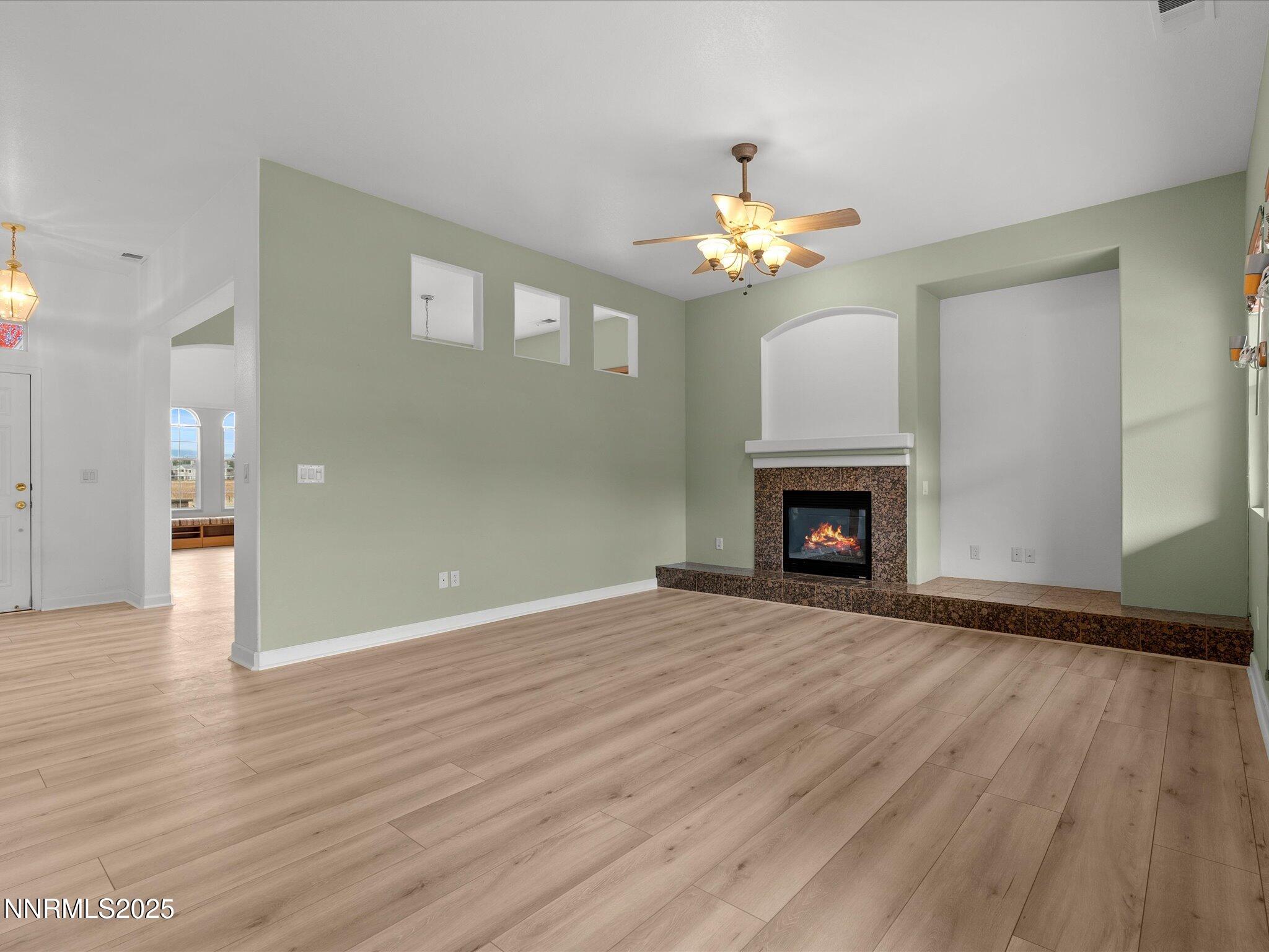 10316 Sterling View Court Reno, NV 89521 - Photo 10 of 41 a view of an empty room with a fireplace and a window