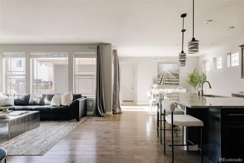 a living room with furniture and floor to ceiling windows
