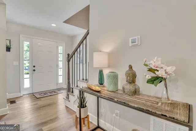 a bathroom with a granite countertop sink a potted plant and a large mirror