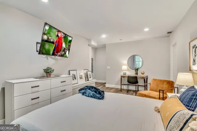 a bedroom with furniture and a flat screen tv
